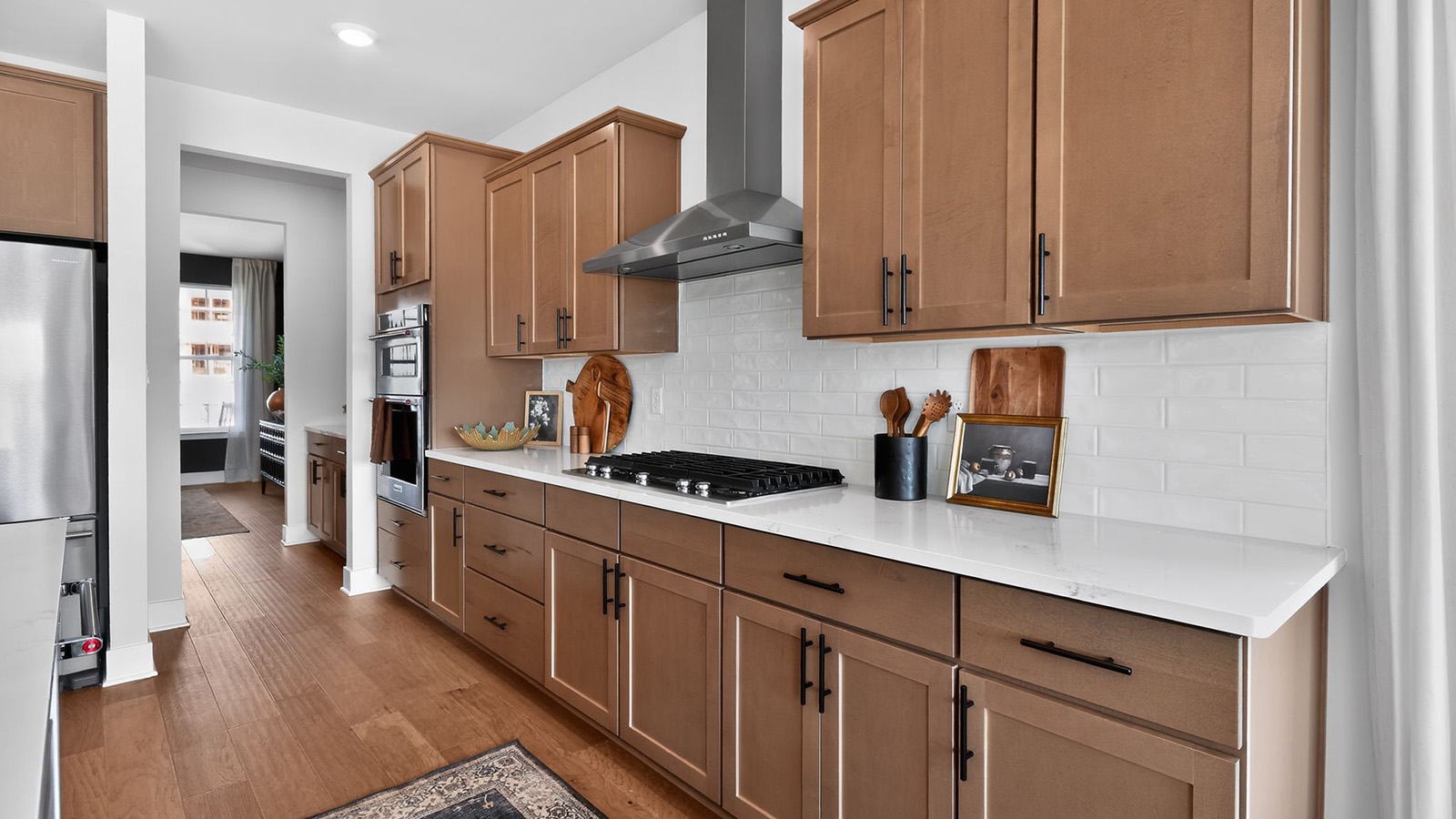 kitchen cabinetry with black handles and stainless steel appliances