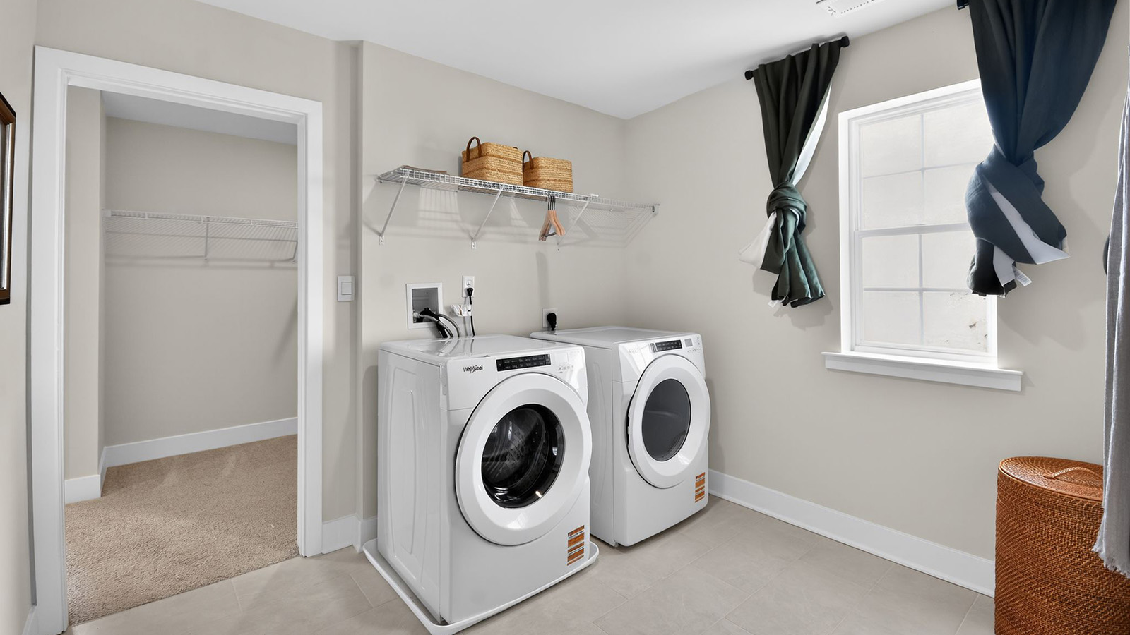 laundry room off the walk in closet in the primary