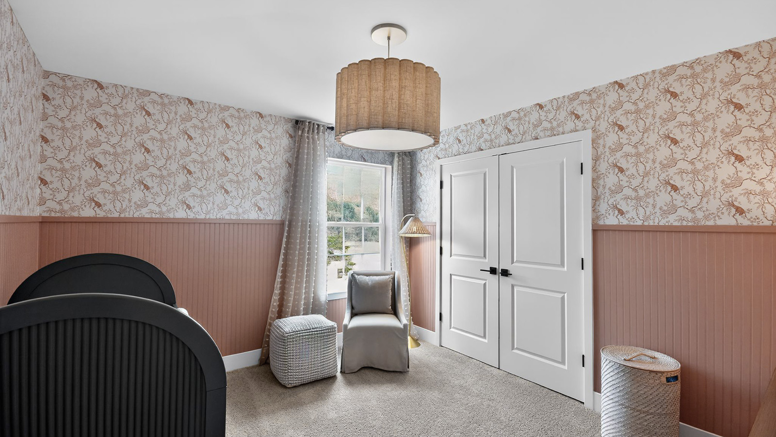 nursery with peach accent tones and large closet