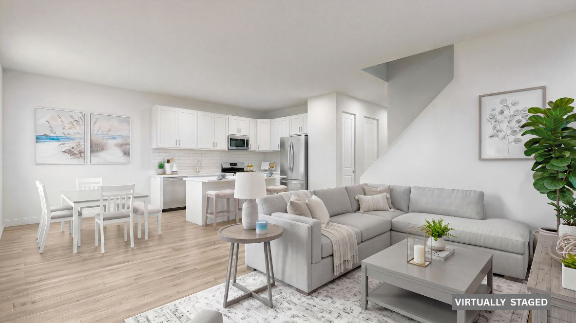 spacious open concept living room with modern design and the kitchen with large quartz island behind