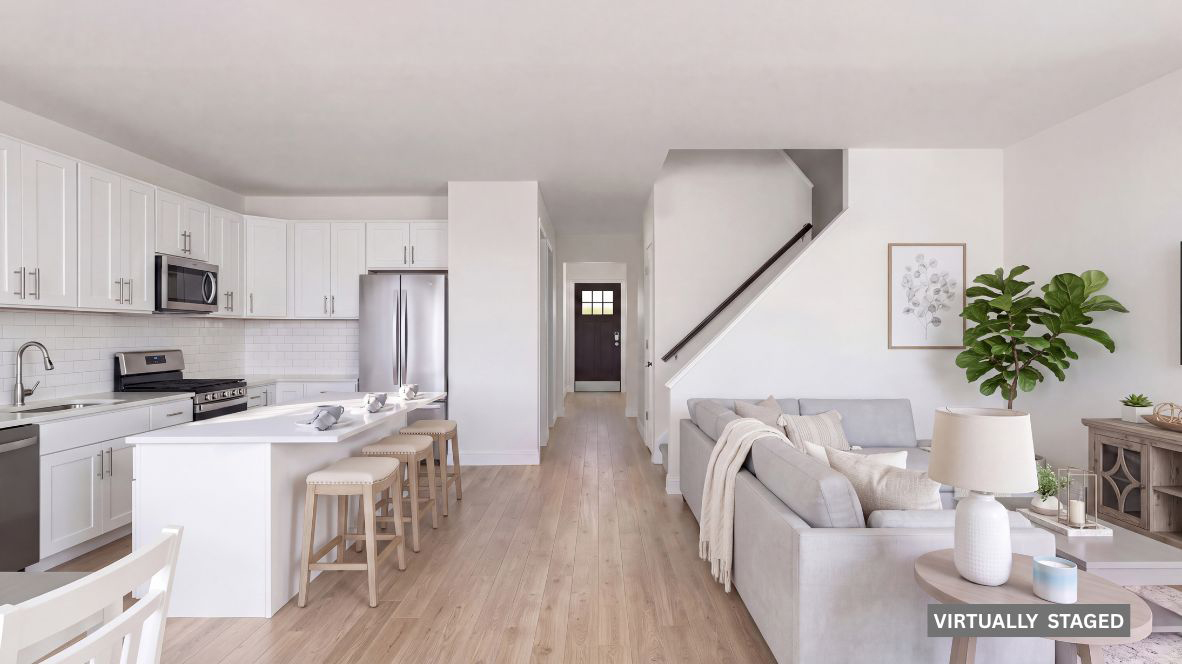 modern front entrance into the Sawyer model featuring a quartz island in the kitchen and spacious living room