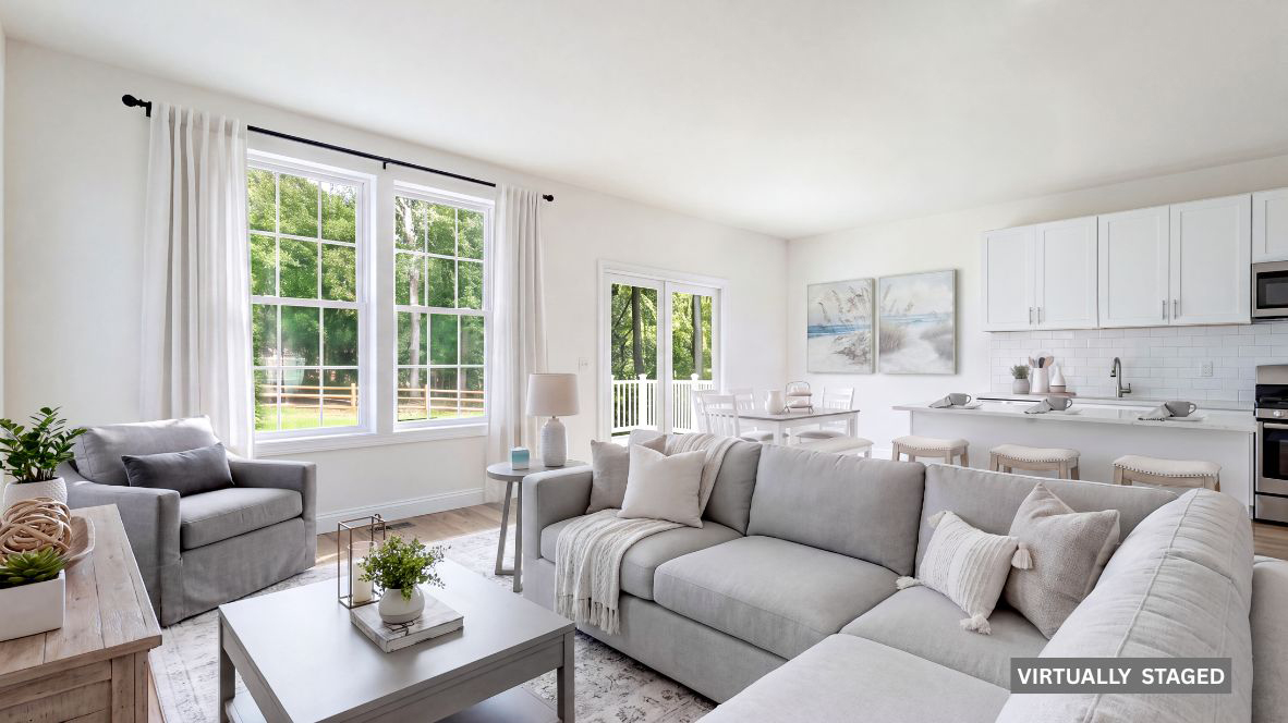 spacious open concept living room with modern design and the kitchen with large quartz island behind