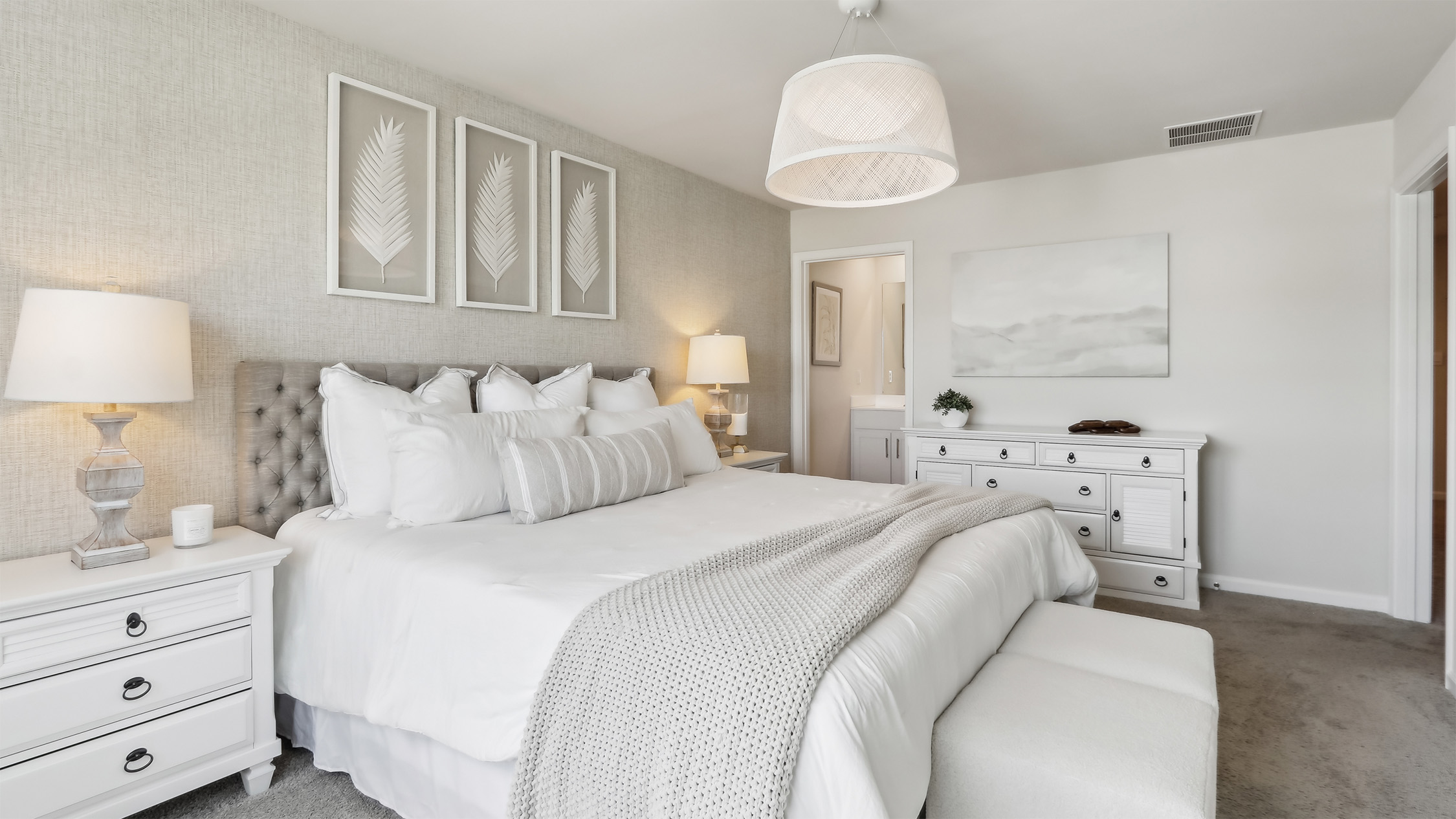 primary bedroom with large walk in closet and full bath