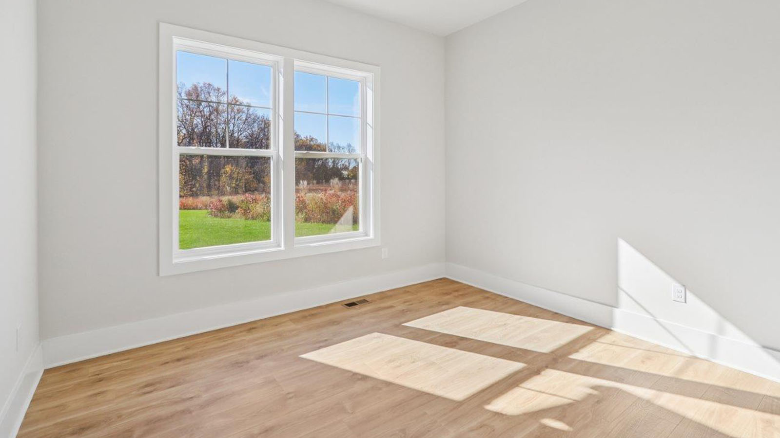 bedroom with hardwood and large windows