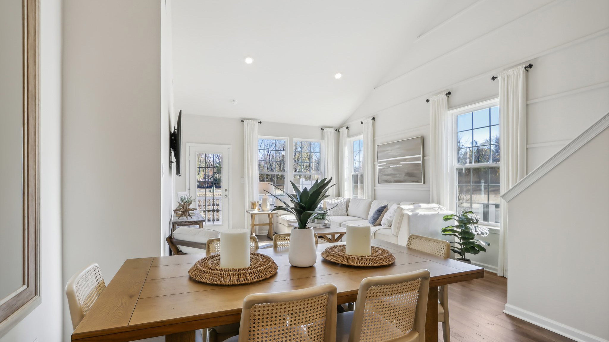 open concept living room and dining table on the main floor