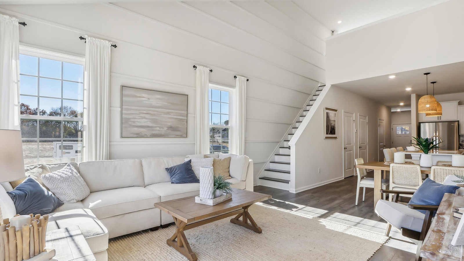 spacious living room with modern design and upstairs loft