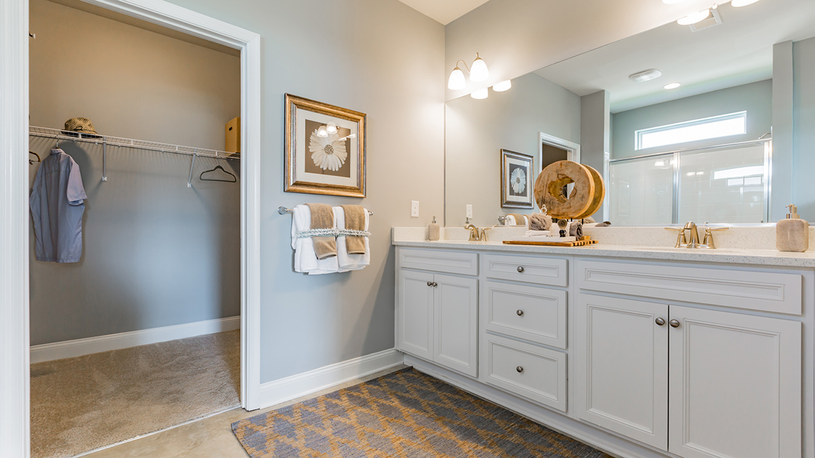The owner’s suite includes a sizeable walk-in closet, double bowl vanity, and luxury owner’s shower.