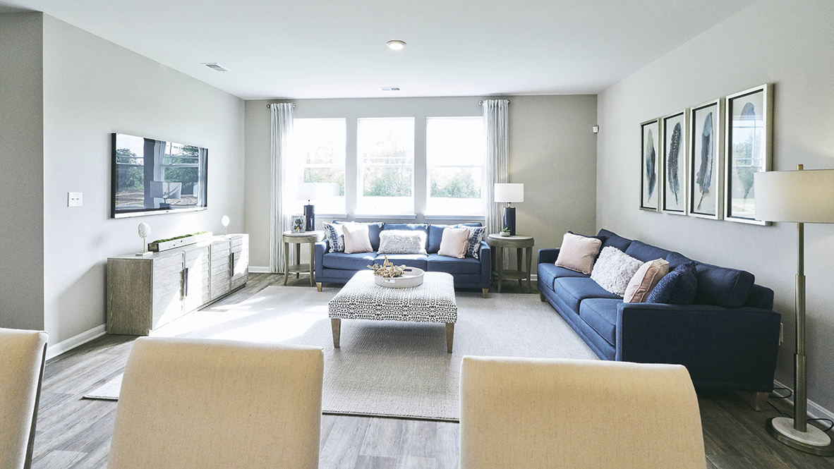 Featuring plank flooring, the kitchen is open to the living room.