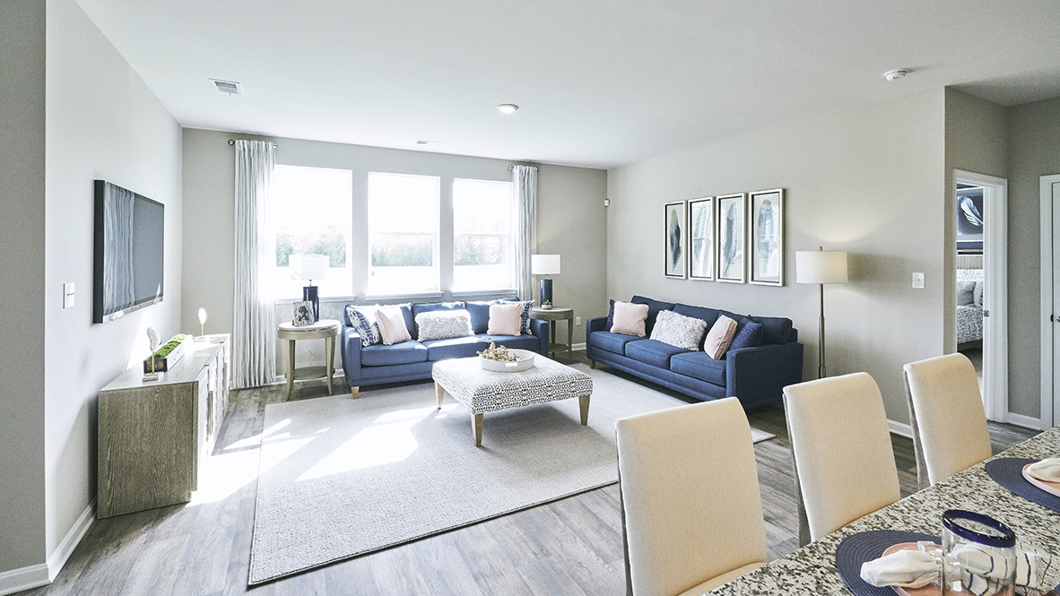 Featuring plank flooring, the kitchen is open to the living room.