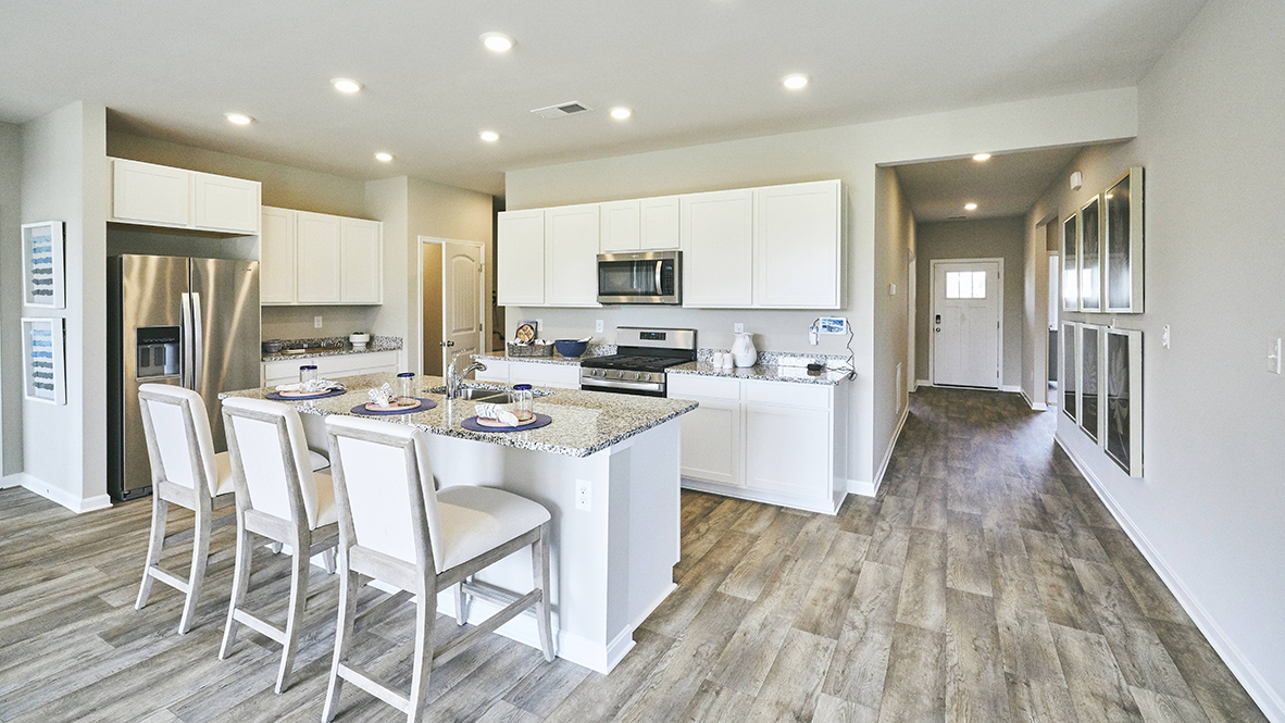 The home's well-designed kitchen features upgraded countertops.