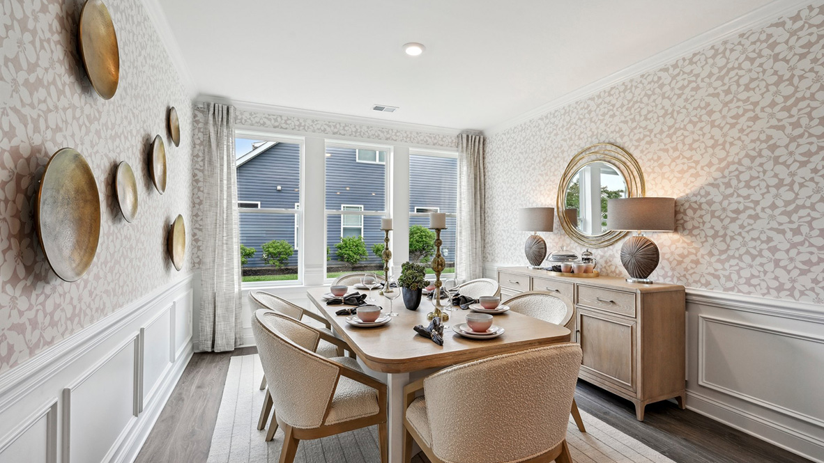 The dining room has beautiful windows across the back of the room.