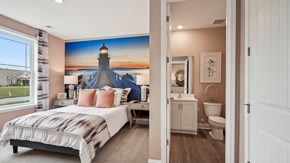 A full bath is next to a guest bedroom.