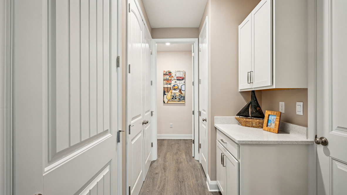 Tucked between the kitchen pantry and the three-car garage, features a coat closet and the laundry room.