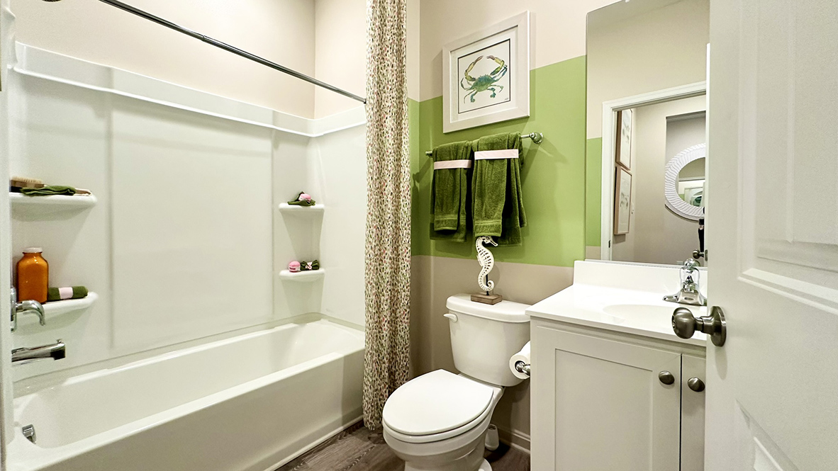 The guest bathroom is across the hall from guest bedroom.