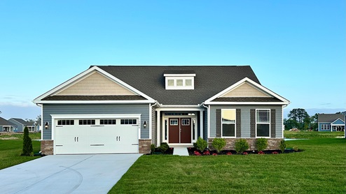 Woodfield Preserve Coastal home with blue siding.