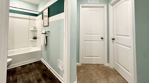 A shared secondary bathroom is located centrally to each bedroom.