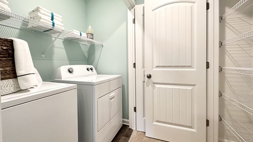 The laundry closet comes complete with a washer and dryer.