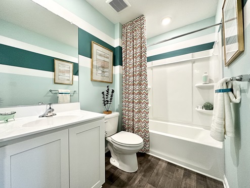 Secondary bathroom with shower, toilet and vanity.