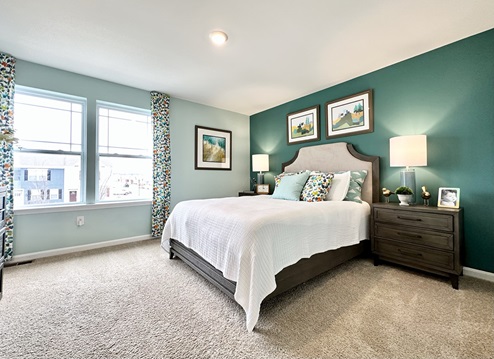 Primary bedroom with large windows.