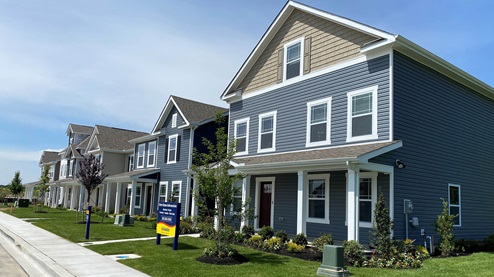 The Simpsons Crossing streetscape showing homes with front porches.