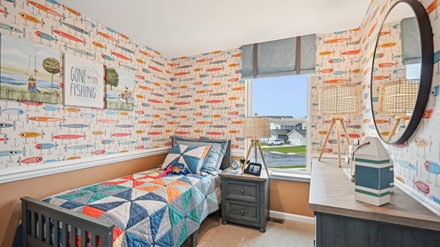 Secondary bedroom with carpet throughout and window.