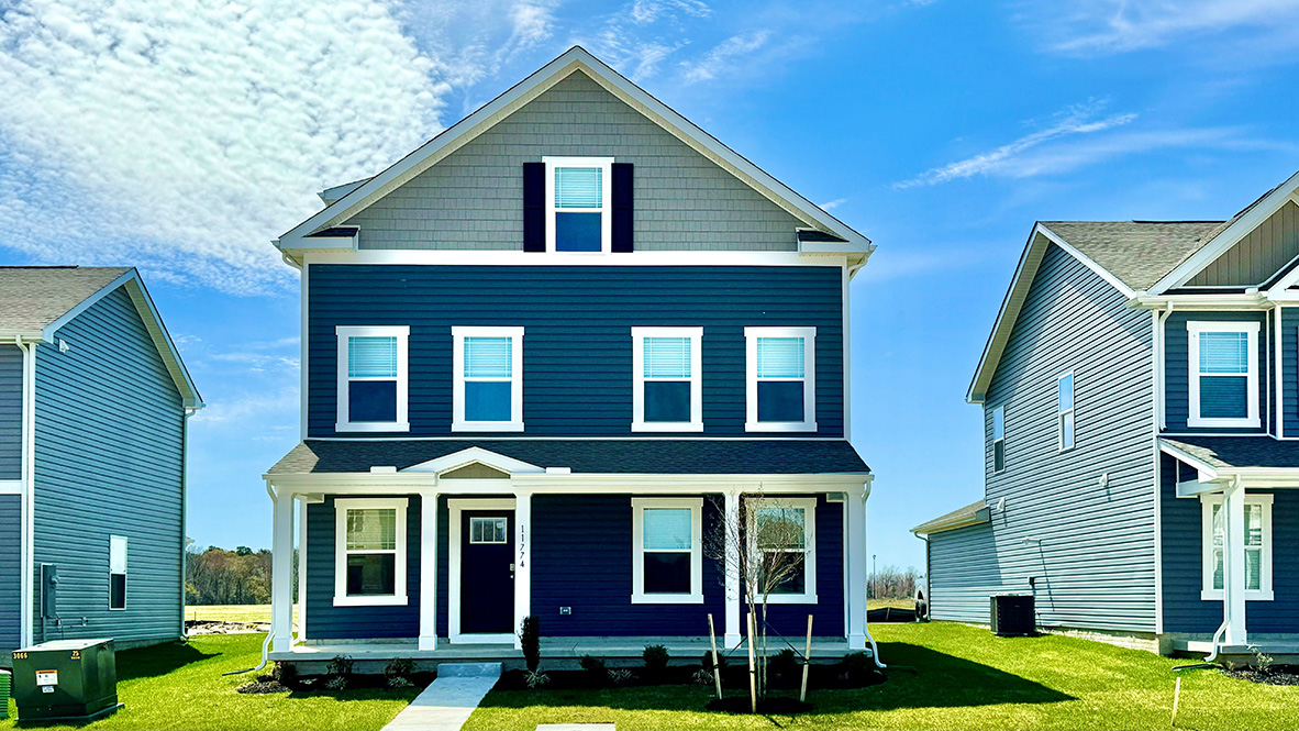 A three-story Verona home with blue siding.