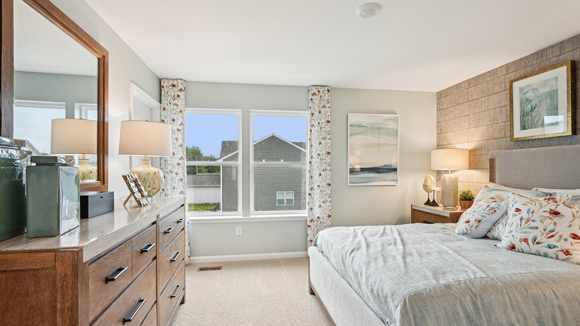 Primary bedroom with large windows.