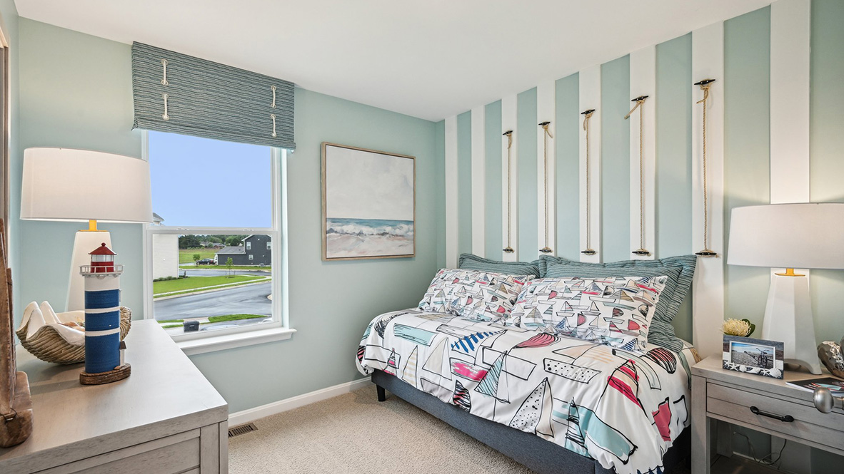 Secondary bedroom with carpet throughout and window.