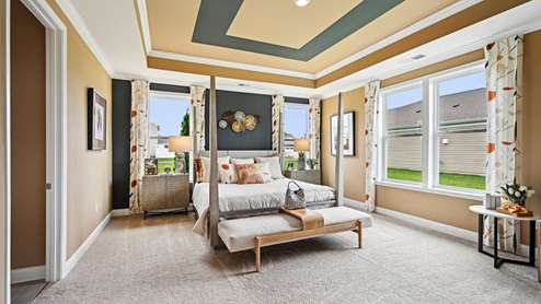 Primary bedroom with large windows.