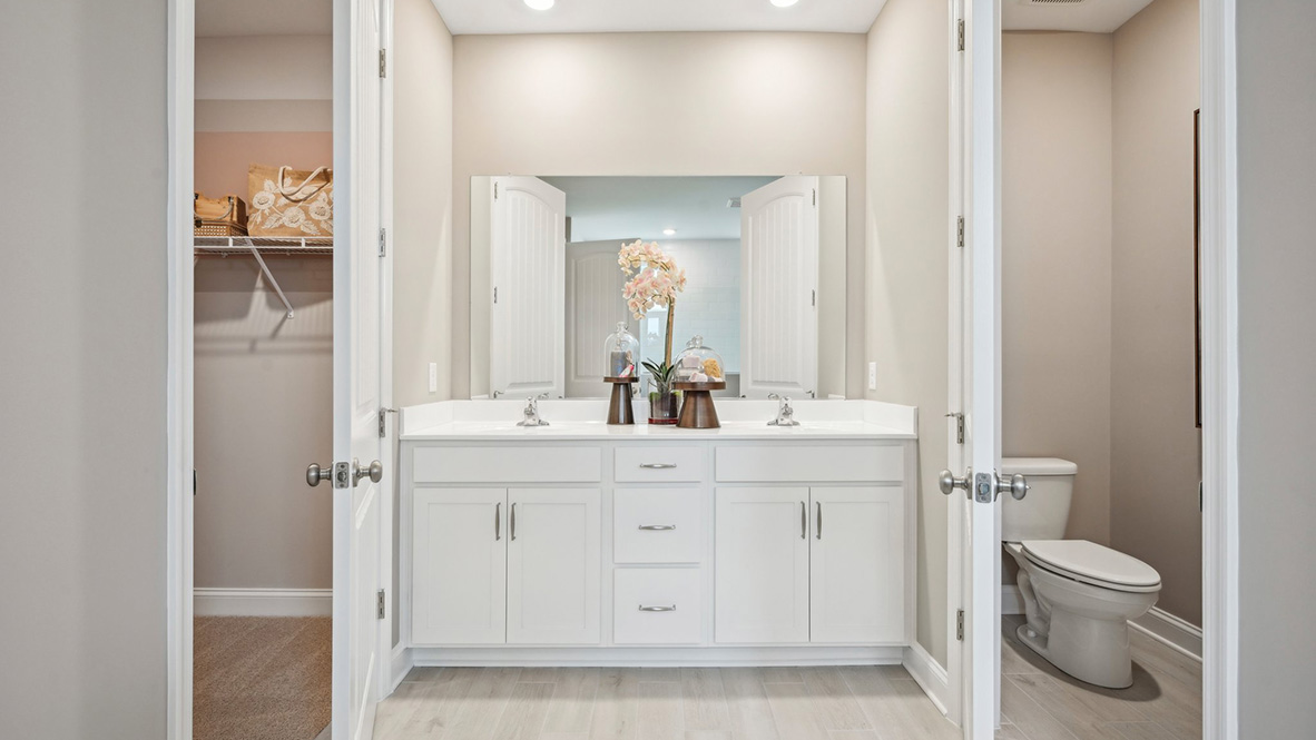 The primary bathroom includes a toilet closet and a double bowl vanity.