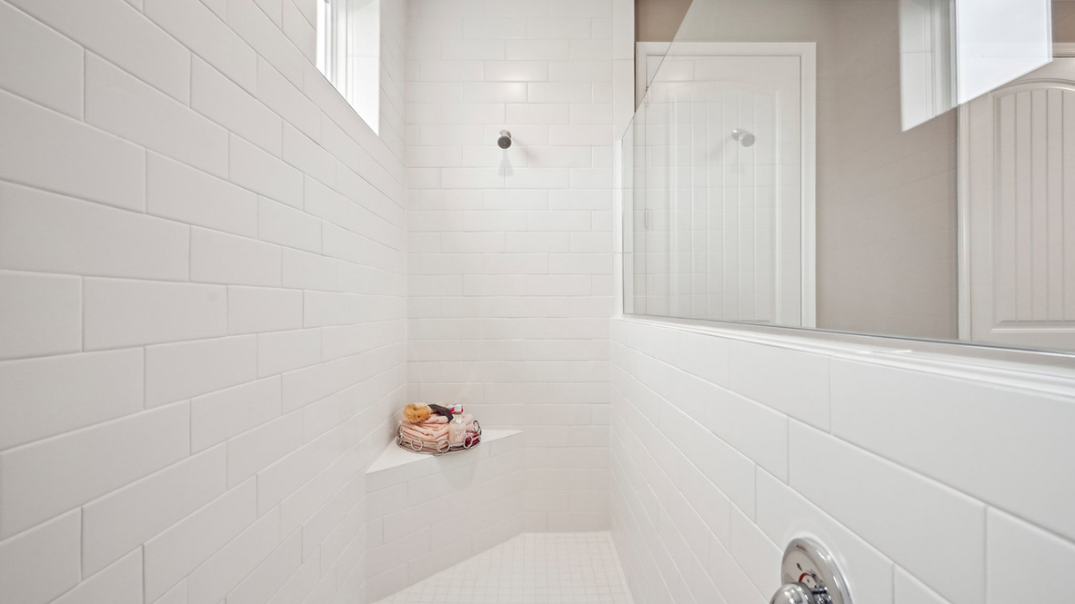 The primary bathroom has a large walk-in shower.