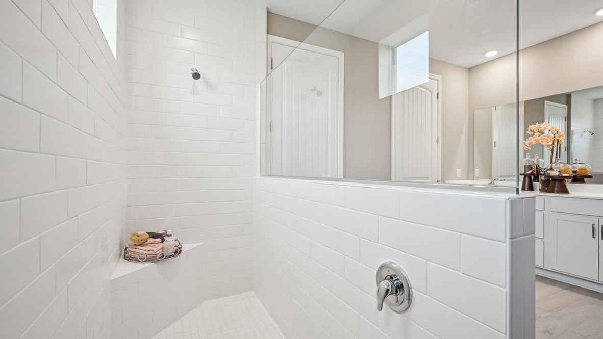 The primary bathroom has a large walk-in shower.