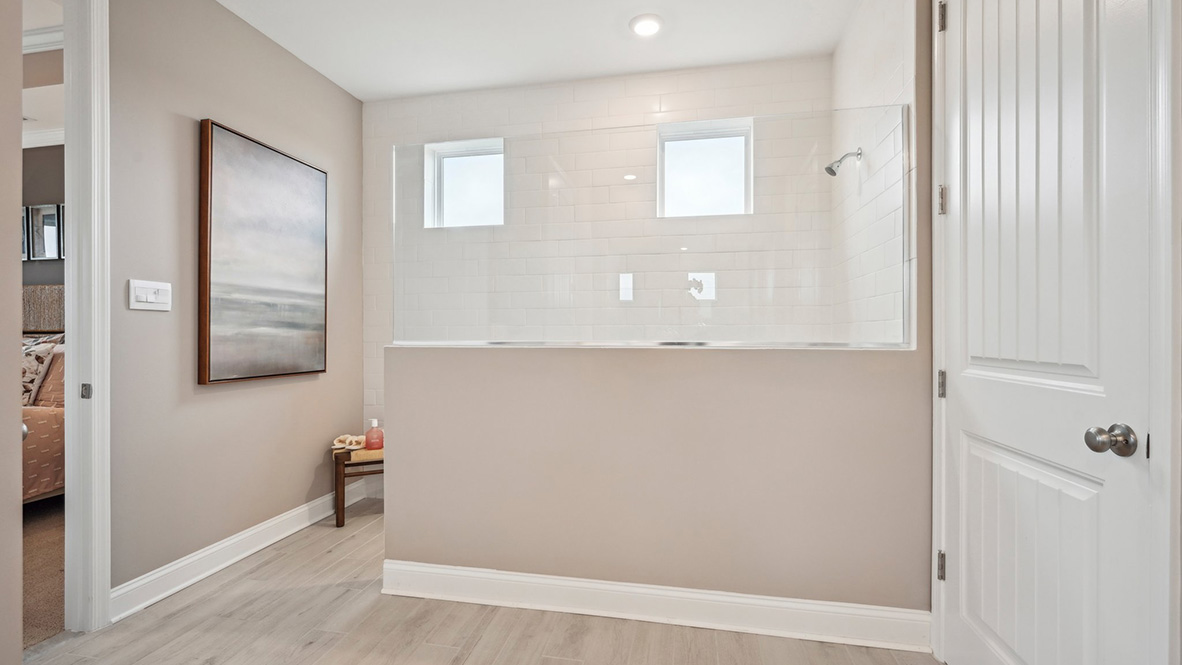 The primary bathroom has a large walk-in shower.