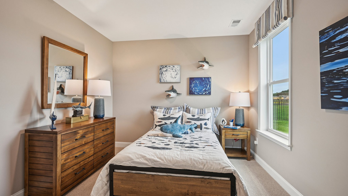 A guest bedroom with a large window.