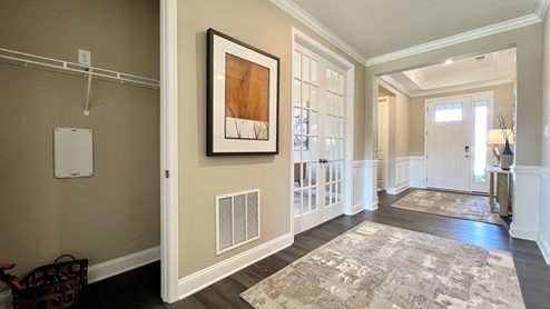 A welcoming foyer leads you to a guest bedroom and the study.