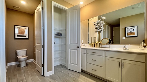 The primary bathroom has a double-bowl vanity, linen closet, and toilet closet.