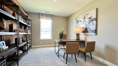 The inviting study is a versatile space with an abundance of natural light.