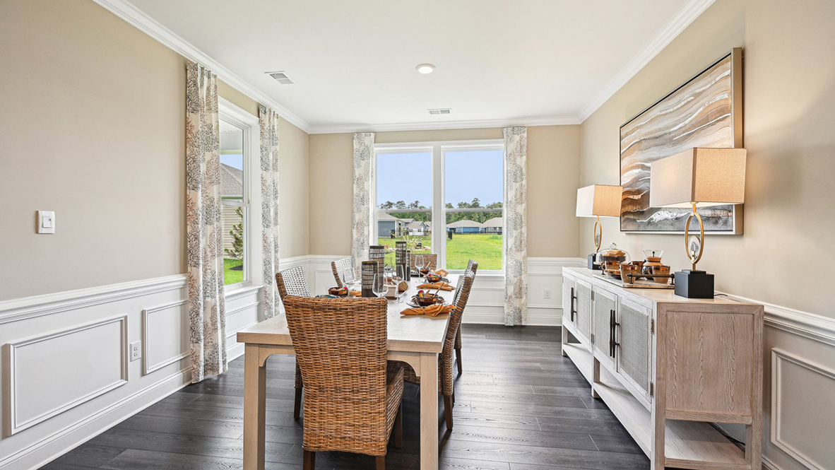 The dining room is surrounded by windows.