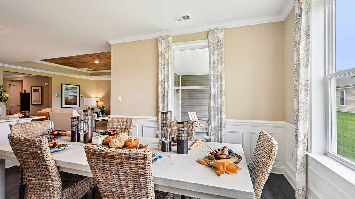 The dining room is surrounded by windows.