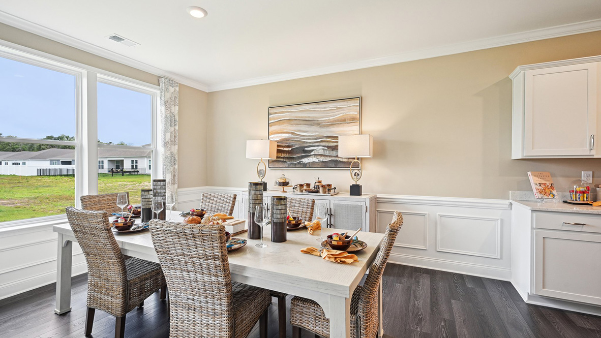 The dining room is surrounded by windows.