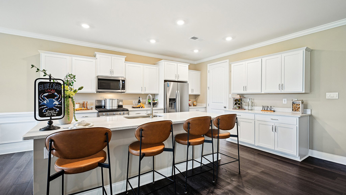 The gourmet kitchen with an expansive island showcases quartz countertops.