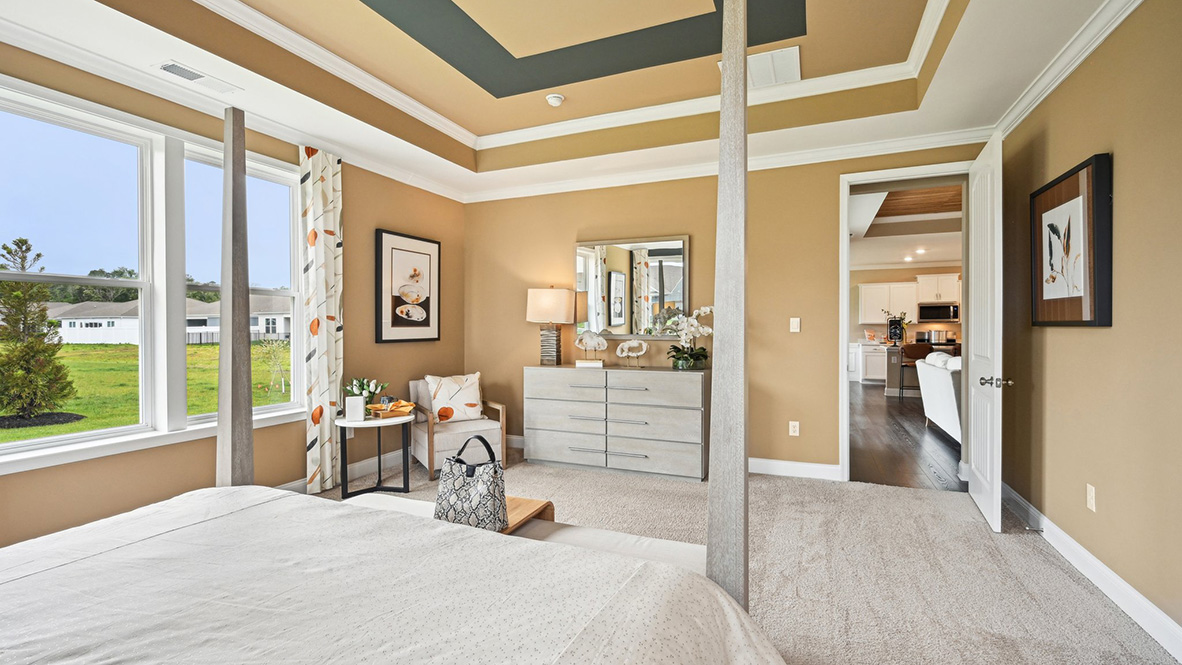 The open-concept great room leads you to the primary bedroom.