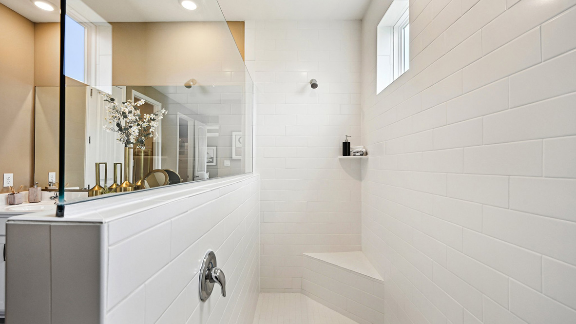 The walk-in shower has two windows along the ceiling for natural light.