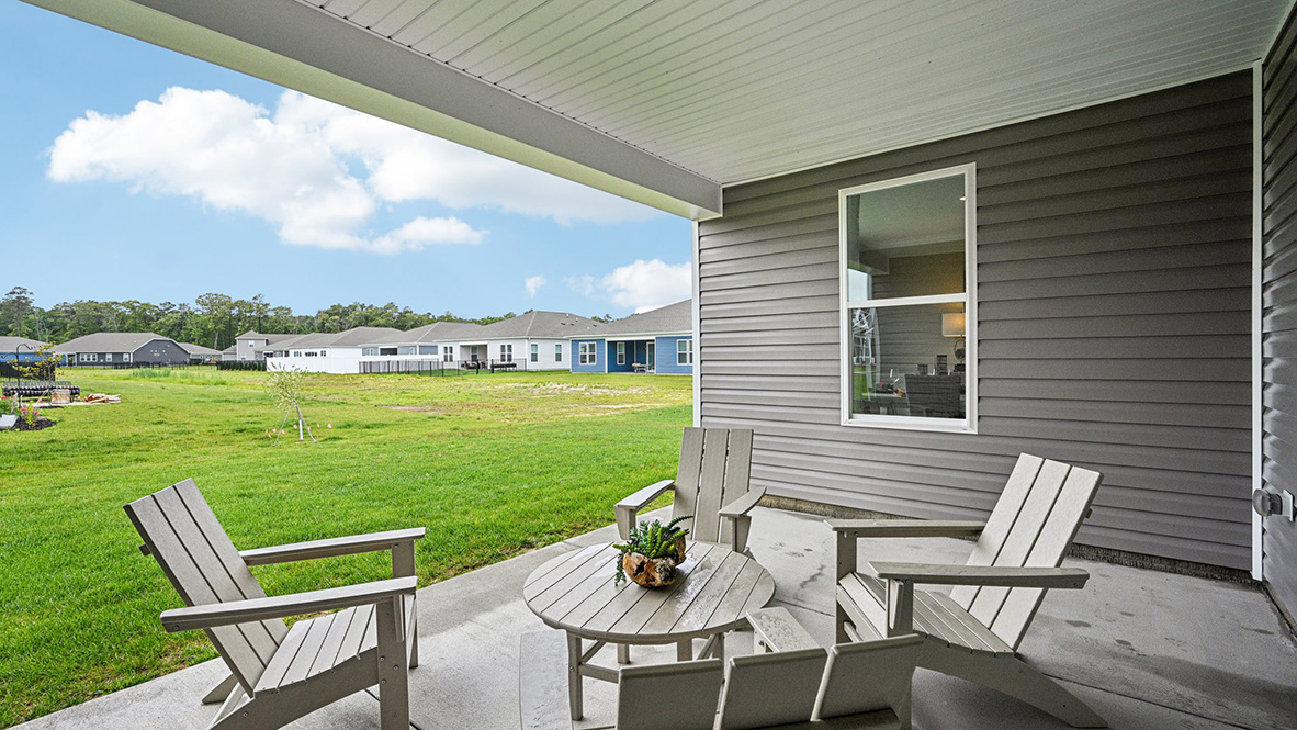 Enjoy the private covered porch in the back of the home overlooking the fully sodded, irrigated, and landscaped yard.