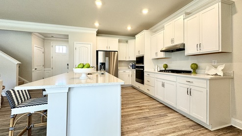 Open-concept kitchen with stainless steel appliances.