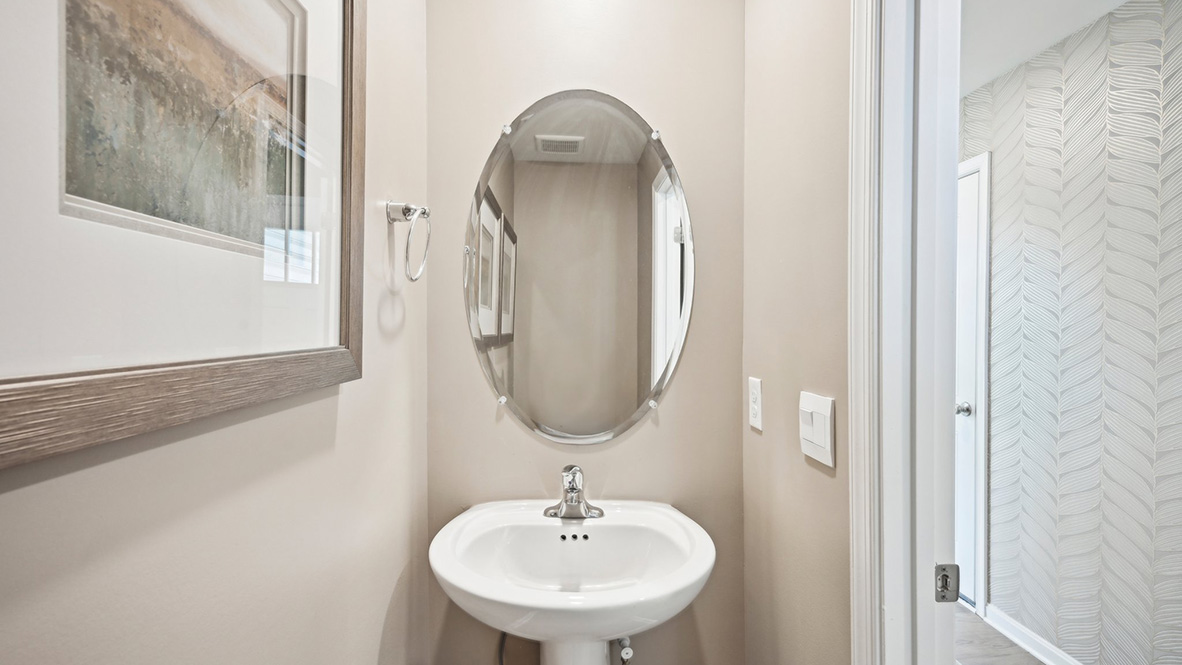 A powder room greets you as you enter this home from the porch.