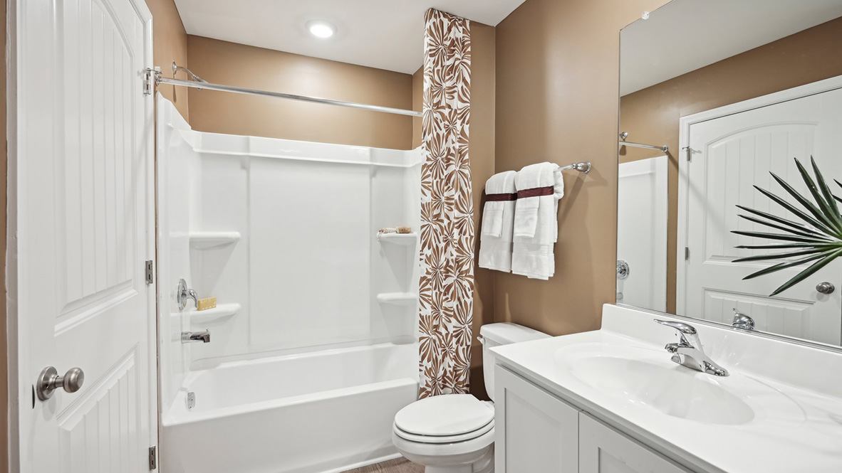 The second full bathroom has a double-bowl vanity and tub shower.