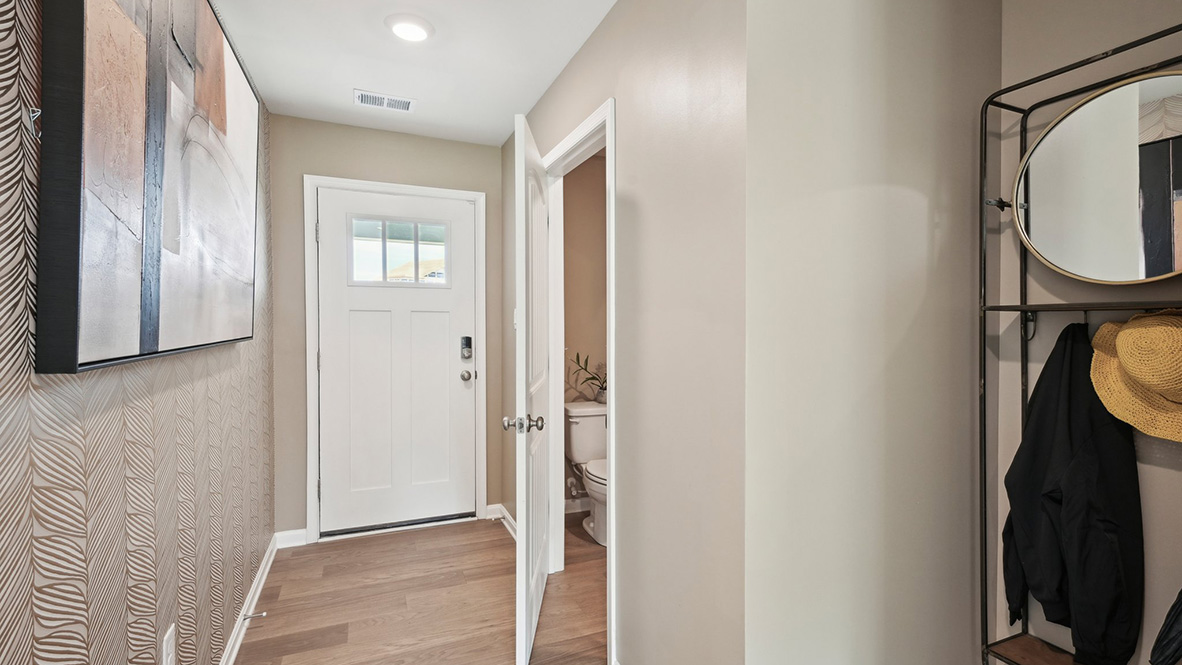 A powder room greets you as you enter this home from the porch.