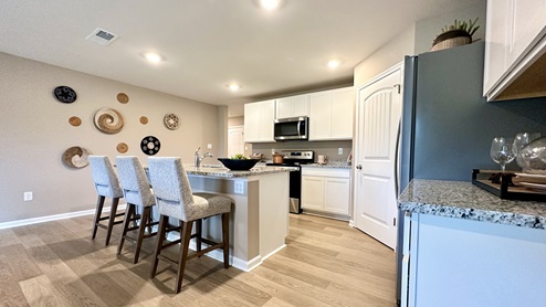 The kitchen includes a large center island with a sink.
