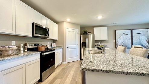 The home has laminate plank flooring throughout the kitchen.